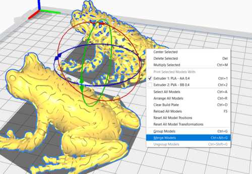 Almost the same screenshot as before of the two submodels of the frog, but here a dropdown menu is presented with the option 'Merge Models' selected.